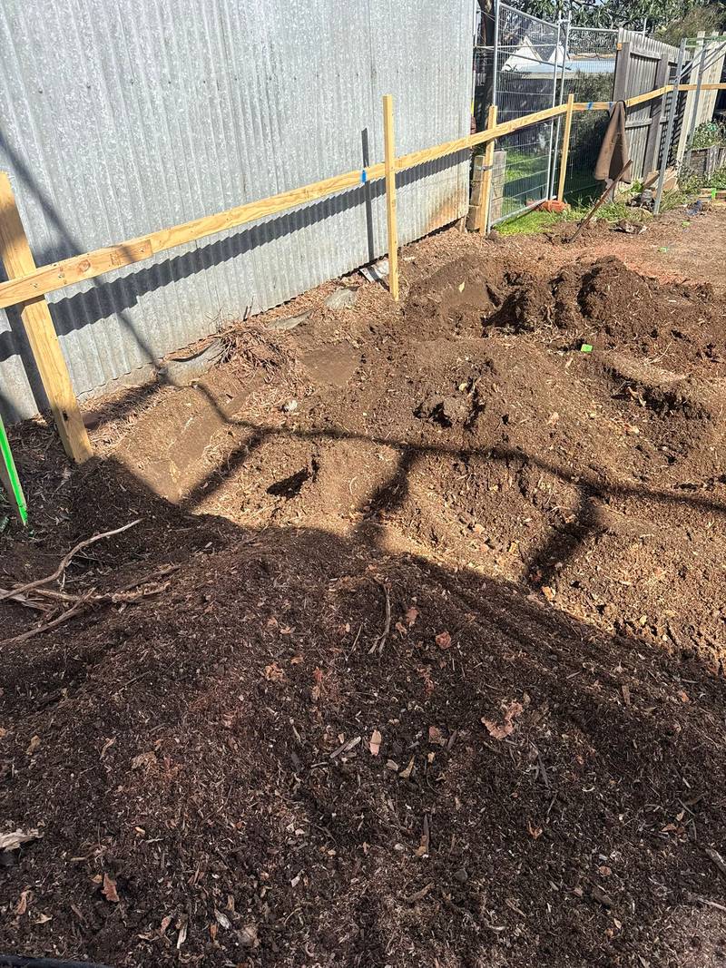 Ground cleared of stumps along the fence line, ready for foundation work